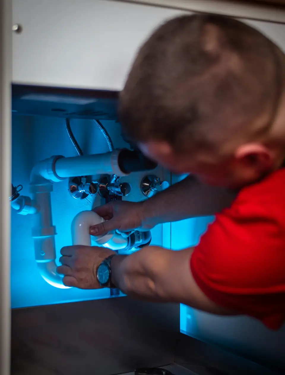Licensed plumber working on a residential repair